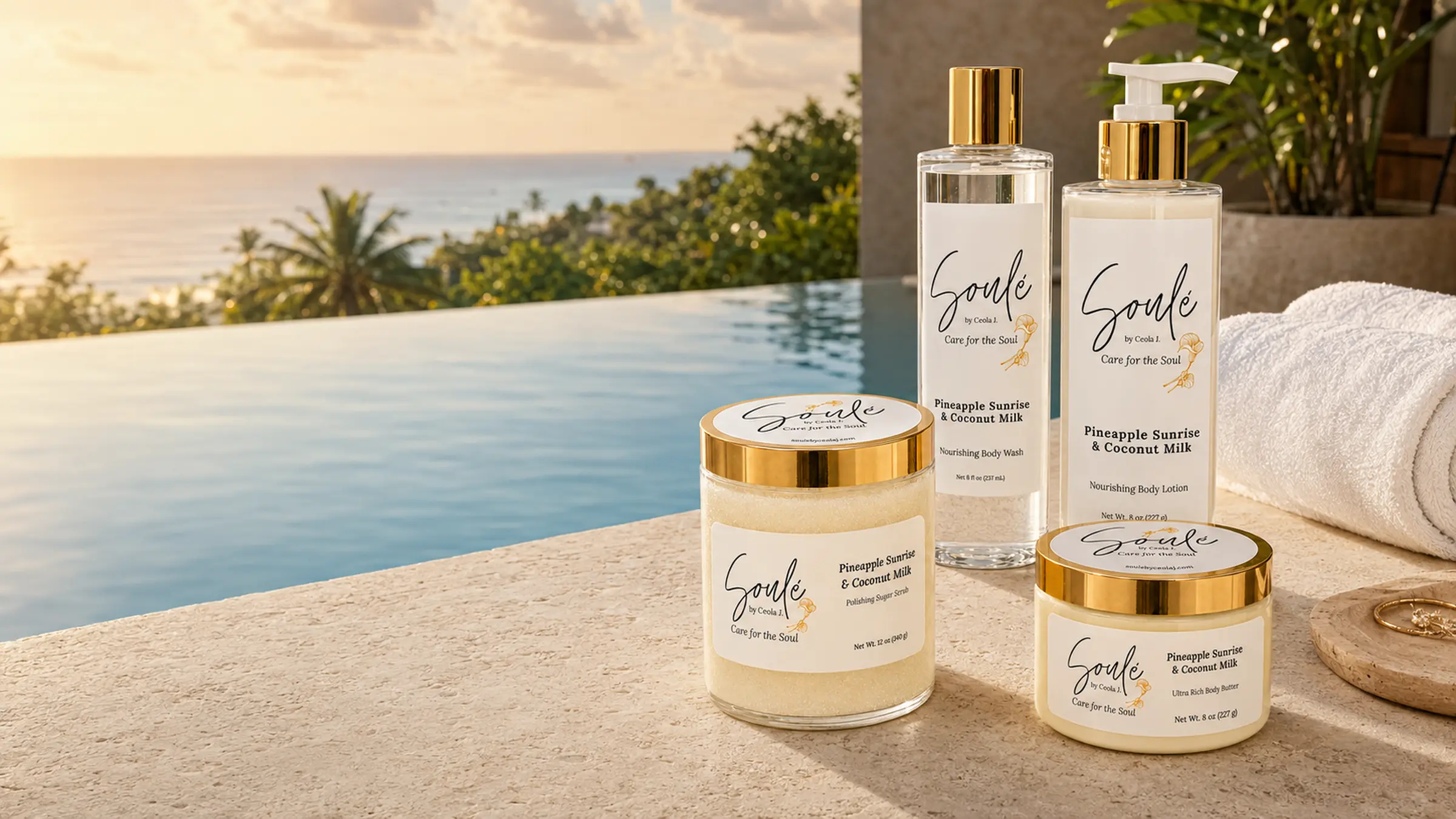 Soulé Pineapple Sunrise & Coconut Milk collection styled at the edge of an infinity pool at sunset