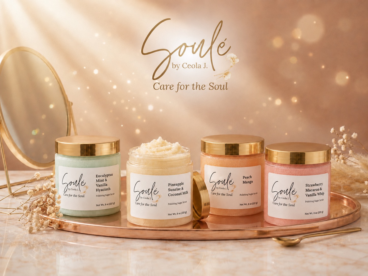 Soulé polishing sugar scrub jars in all four scent collections — Eucalyptus Mint & Vanilla Hyacinth, Pineapple Sunrise & Coconut Milk, Peach Mango, and Strawberry Macaron & Vanilla Whip