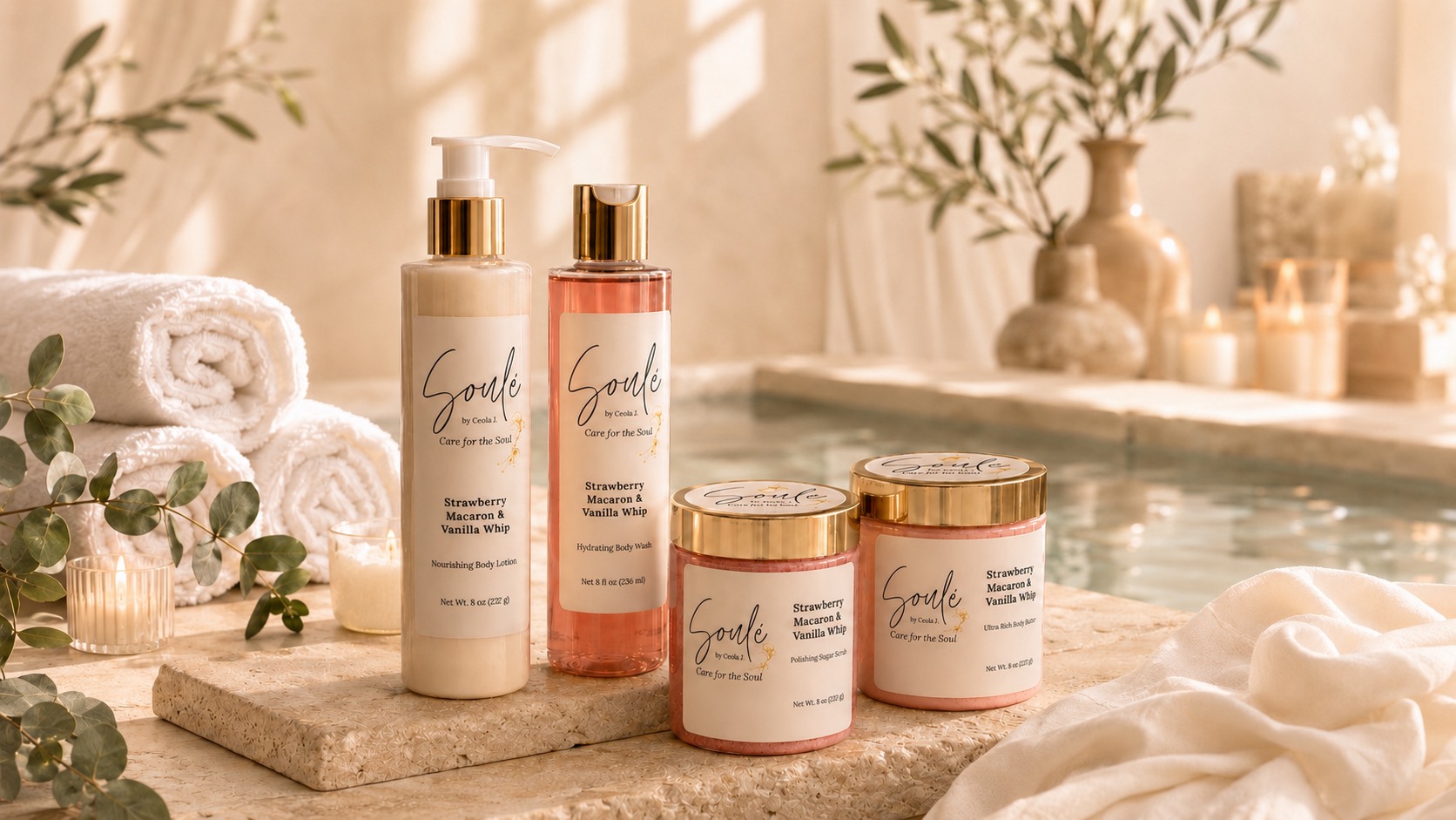Soulé body care collection styled with rolled towels and candles at the edge of a spa pool